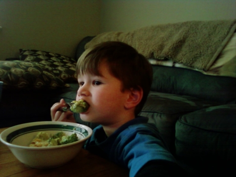 Eating his broccoli